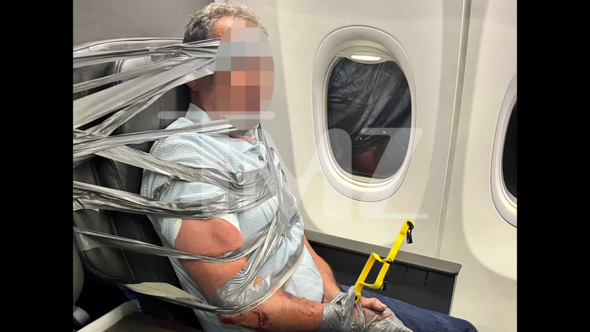 A passenger is duct-taped to an airplane seat on board an American Airlines flight to Newark from DFW Airport on September 3, 2026.